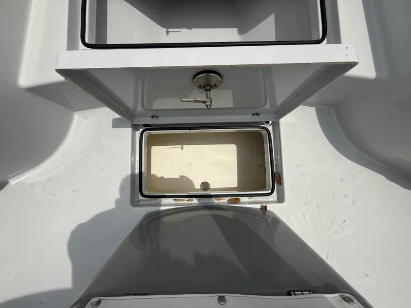 Slide: The Image of 2024 Pathfinder 2600 HPS boat storage compartments with open lids, showcasing interior space. - 21