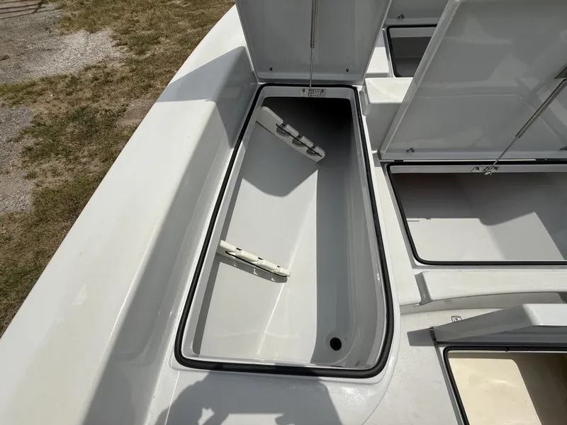 Slide: The Image of 2024 Pathfinder 2600 HPS boat storage compartments open, showcasing interior design. - 22