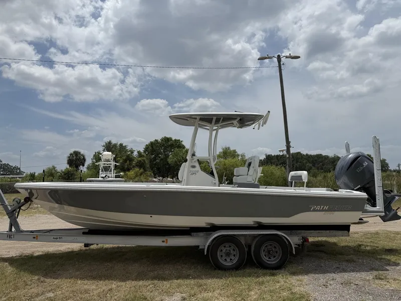 Slide: The Image of 2024 Pathfinder 2600 HPS boat on trailer under cloudy sky. - 28