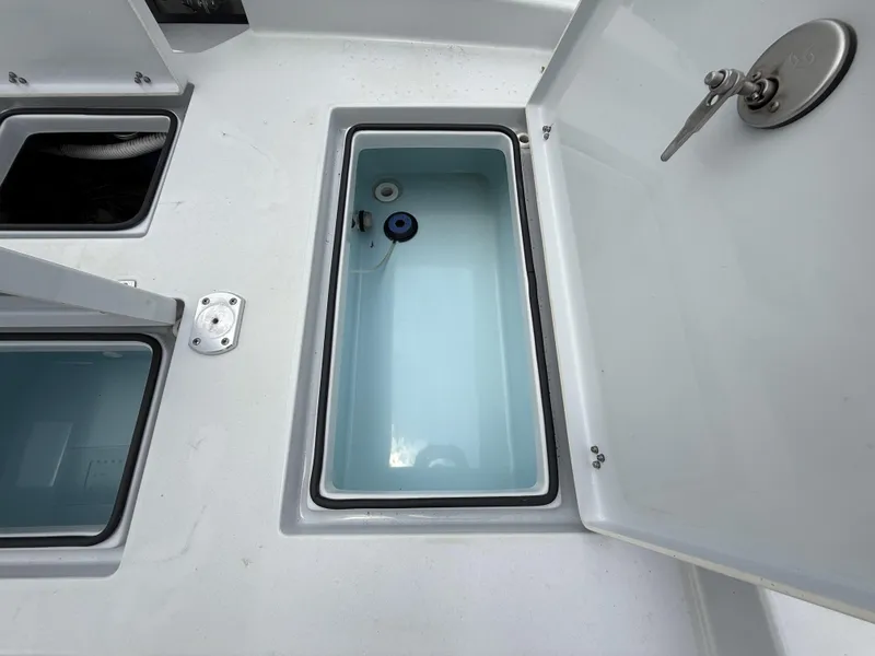Slide: The Image of 2024 Pathfinder 2600 HPS boat storage compartments with open lids, showcasing interior design. - 36