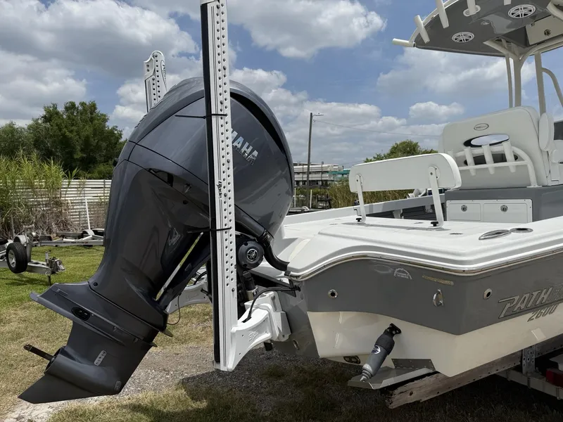 Slide: The Image of 2024 Pathfinder 2600 HPS boat with Yamaha outboard motor, parked on grass. - 4