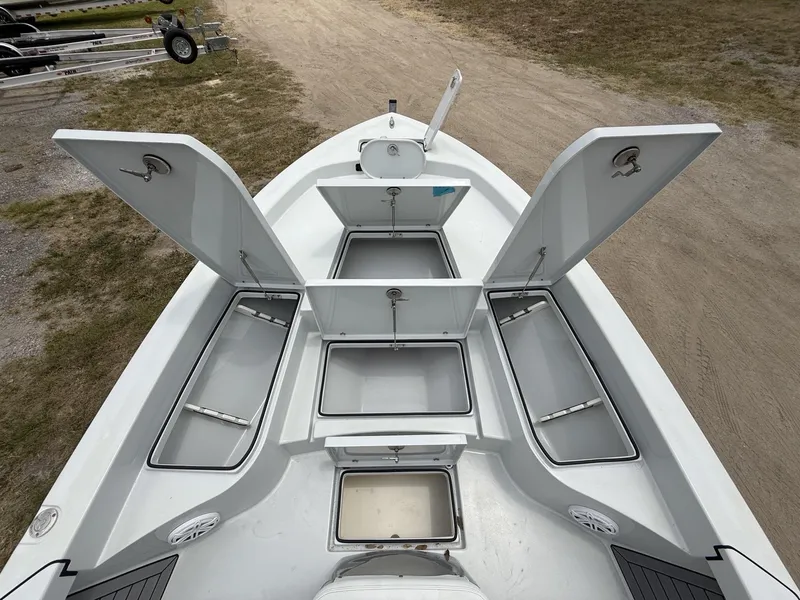 Slide: The Image of 2024 Pathfinder 2600 HPS boat with open storage compartments on a trailer. - 43