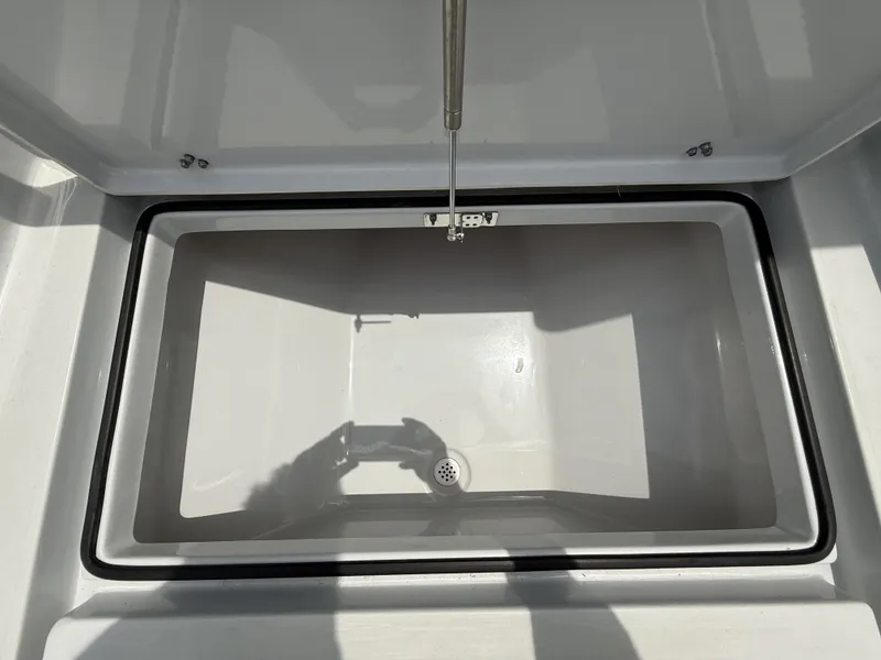 Slide: The Image of 2024 Pathfinder 2600 HPS storage compartment, open and empty, with a drain at the bottom. - 44