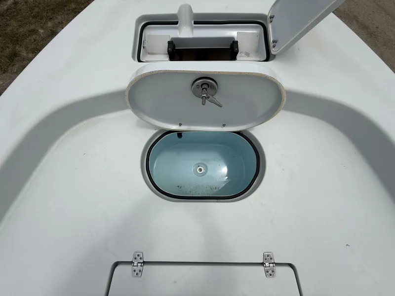 Slide: The Image of 2024 Pathfinder 2600 HPS boat livewell with open lid, showcasing interior design. - 46