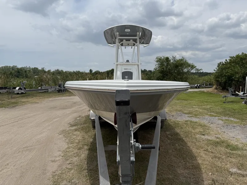 Slide: The Image of 2024 Pathfinder 2600 HPS boat on trailer, parked outdoors under cloudy sky. - 6
