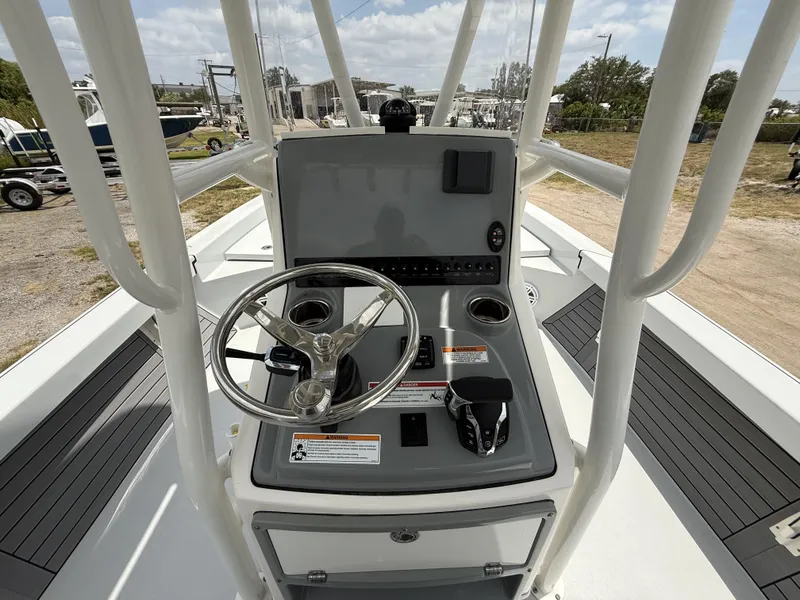 Slide: The Image of 2024 Pathfinder 2600 HPS boat console with steering wheel and controls. - 9