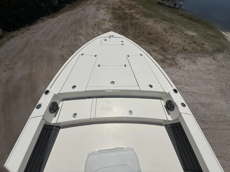 Slide: The Image of 2024 Pathfinder 2500 Hybrid boat on a sandy shore, showcasing deck layout. - 11