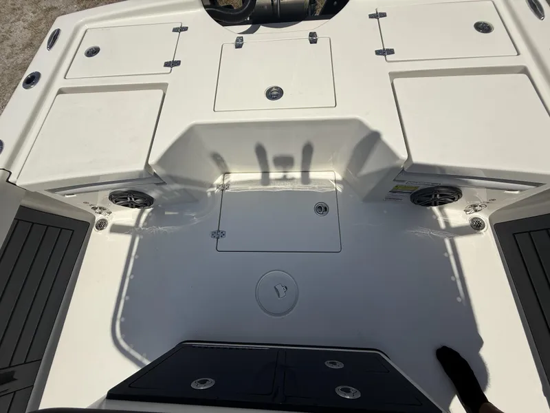 Slide: The Image of 2024 Pathfinder 2500 Hybrid boat deck with storage compartments and speakers. - 19