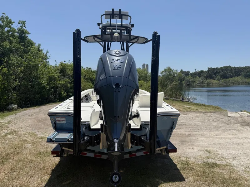 Slide: The Image of 2024 Pathfinder 2500 Hybrid boat with powerful outboard motor near a serene lake. - 3