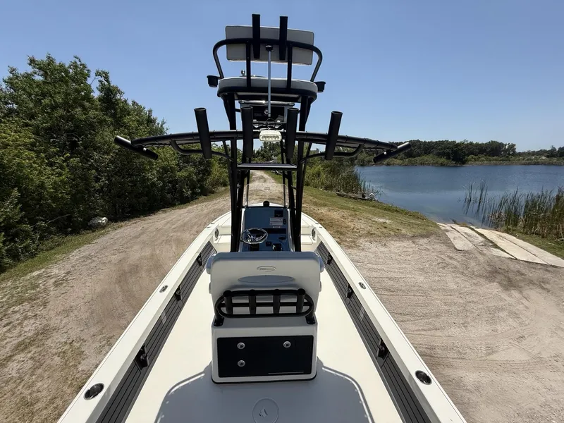 Slide: The Image of 2024 Pathfinder 2500 Hybrid boat on a lakeside dirt path, ready for launch. - 33