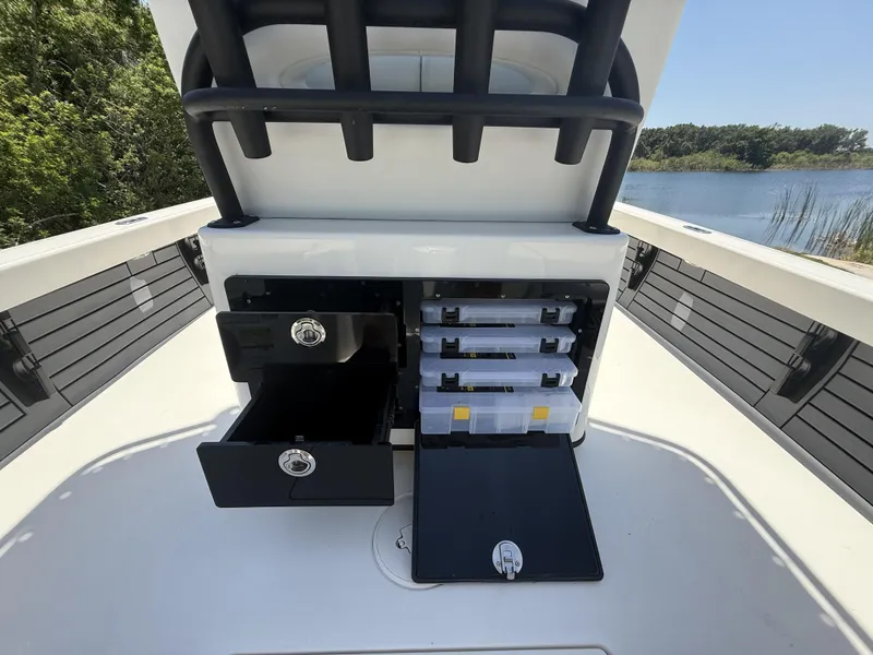 Slide: The Image of 2024 Pathfinder 2500 Hybrid boat storage compartments with open drawers and tackle boxes. - 39