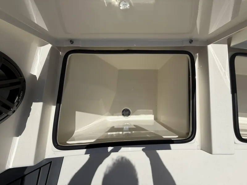 Slide: The Image of 2024 Pathfinder 2500 Hybrid storage compartment with drain, open lid, and speaker detail. - 43