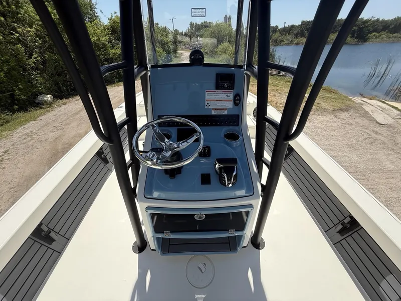 Slide: The Image of 2024 Pathfinder 2500 Hybrid boat console with steering wheel, controls, and water view. - 8