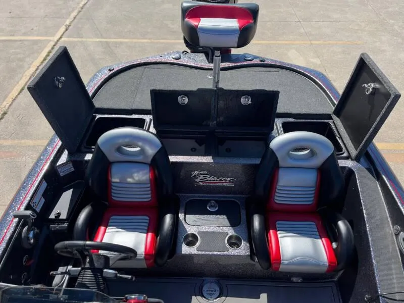 Slide: The Image of 2020 Blazer 625 Pro Elite boat docked on a calm lake. - 12