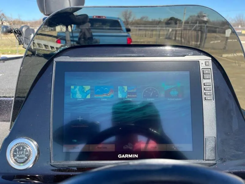 Slide: The Image of 2020 Blazer 625 Pro Elite boat cockpit with steering wheel and red-gray seat. - 20