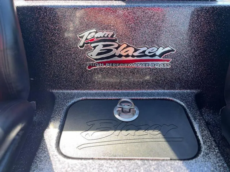 Slide: The Image of Blazer 625 Pro Elite 2020 boat with open storage compartments in a parking lot. - 21