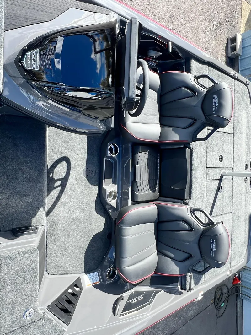 Slide: The Image of 2025 Skeeter ZXR 21 boat interior with sleek black seats and modern dashboard. - 10