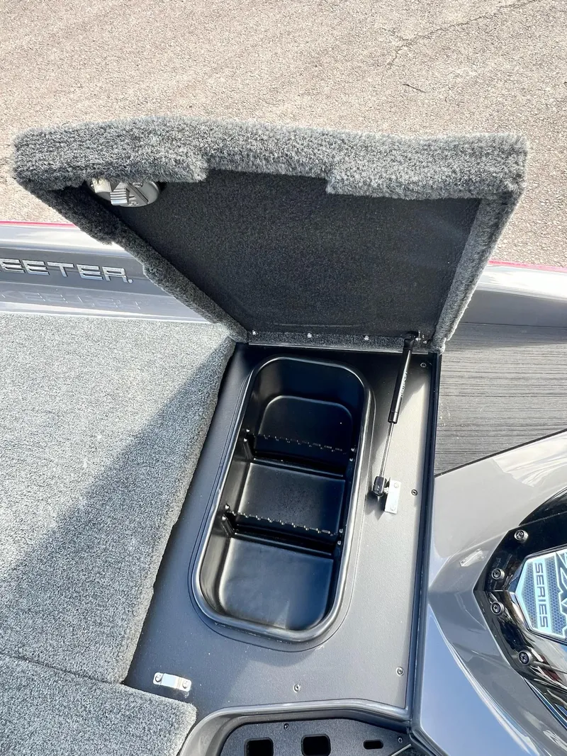 Slide: The Image of Open storage compartment on 2025 Skeeter ZXR 21 boat deck. - 12