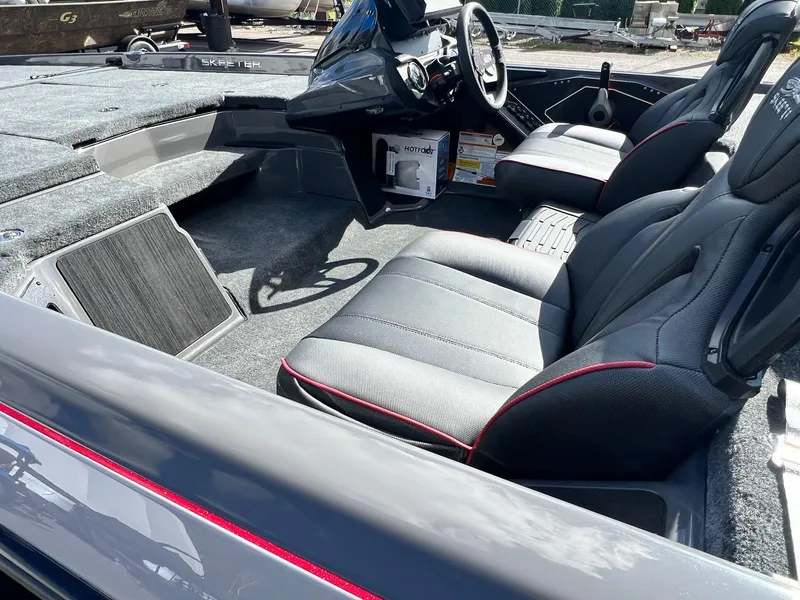 Slide: The Image of 2025 Skeeter ZXR 21 boat interior with sleek black seats and modern dashboard. - 15