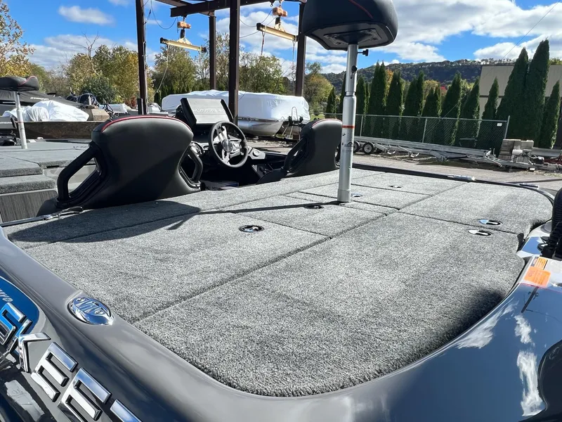 Slide: The Image of 2025 Skeeter ZXR 21 boat with spacious deck and modern seating under a clear sky. - 22