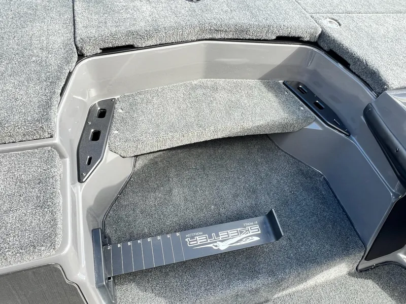 Slide: The Image of 2025 Skeeter ZXR 21 boat interior with gray carpet and step detail. - 27