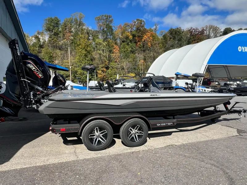 Slide: The Image of 2025 Skeeter ZXR 21 boat on trailer, parked outdoors under blue sky. - 3