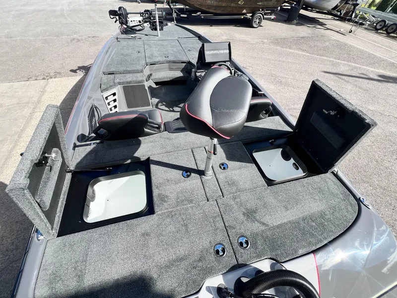 Slide: The Image of 2025 Skeeter ZXR 21 boat interior with open storage compartments and seating. - 30