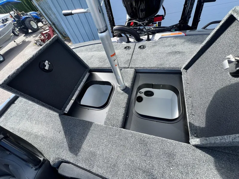Slide: The Image of 2025 Skeeter ZXR 21 boat storage compartments with open lids, showcasing interior design. - 34