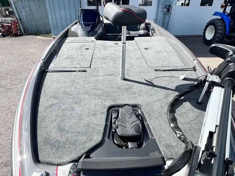 Slide: The Image of 2025 Skeeter ZXR 21 boat deck with seating and equipment, parked outdoors. - 36