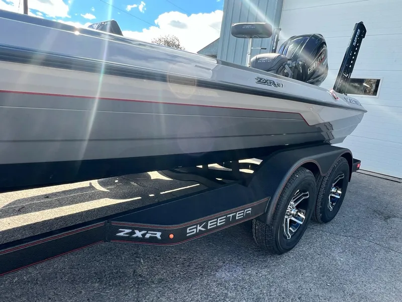 Slide: The Image of 2025 Skeeter ZXR 21 boat on trailer, sunlight reflecting off sleek design. - 38
