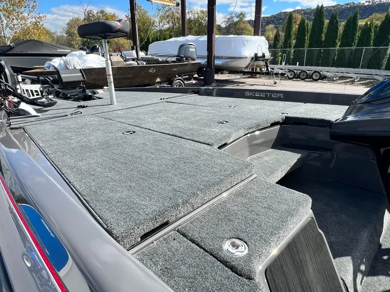 Slide: The Image of 2025 Skeeter ZXR 21 boat deck with carpeted surface and seating. - 4