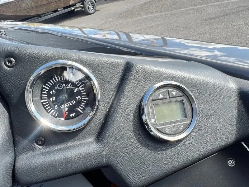 Slide: The Image of Close-up of 2025 Skeeter ZXR 21 boat dashboard with water pressure gauge and digital display. - 8