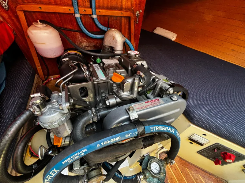 Slide: The Image of Engine compartment of a 1982 J Boats 30 sailboat, featuring detailed mechanical components. - 14