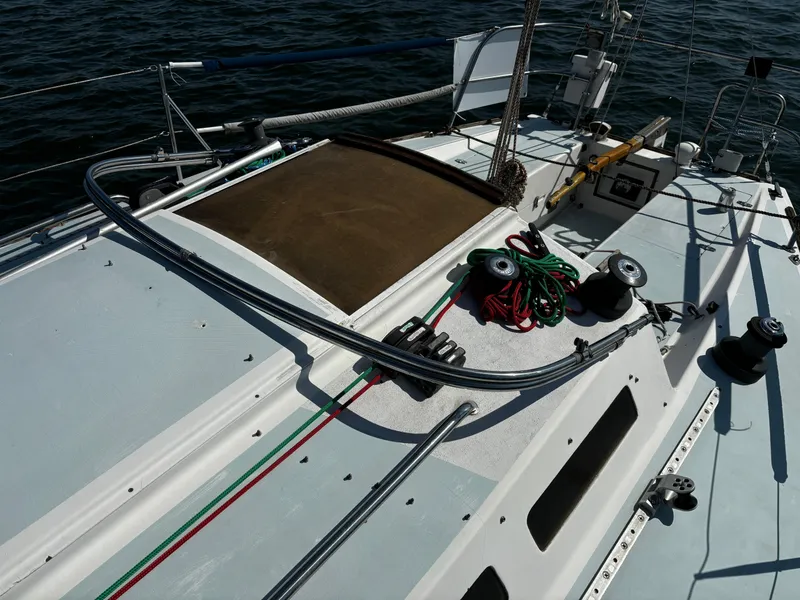 Slide: The Image of 1982 J Boats 30 sailboat deck with ropes and winches on the water. - 5