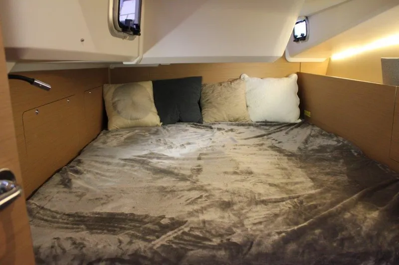 Slide: The Image of Cozy cabin interior of 2024 Jeanneau Sun Odyssey 490 sailboat with plush bedding. - 32