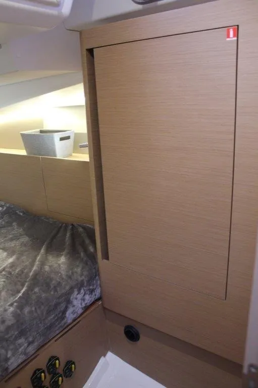 Slide: The Image of Interior cabin of 2024 Jeanneau Sun Odyssey 490 yacht, featuring sleek wood paneling. - 34