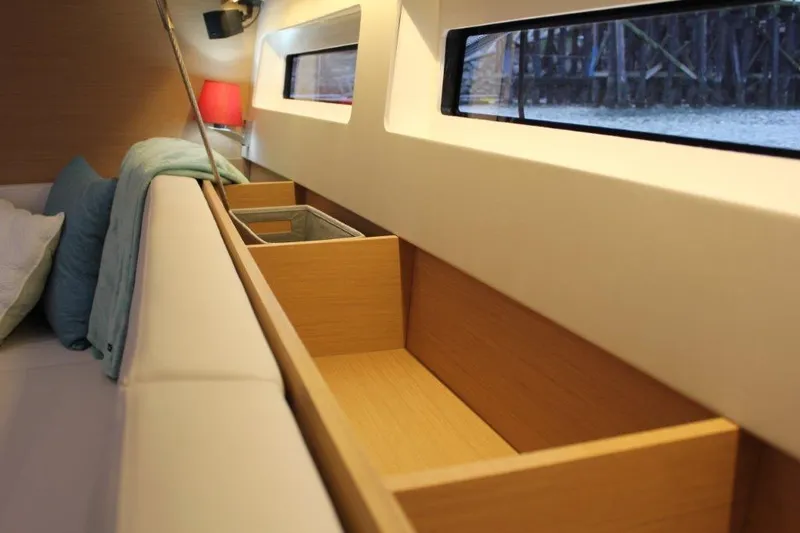 Slide: The Image of Interior of 2024 Jeanneau Sun Odyssey 490 yacht, featuring sleek wooden storage and modern design. - 41