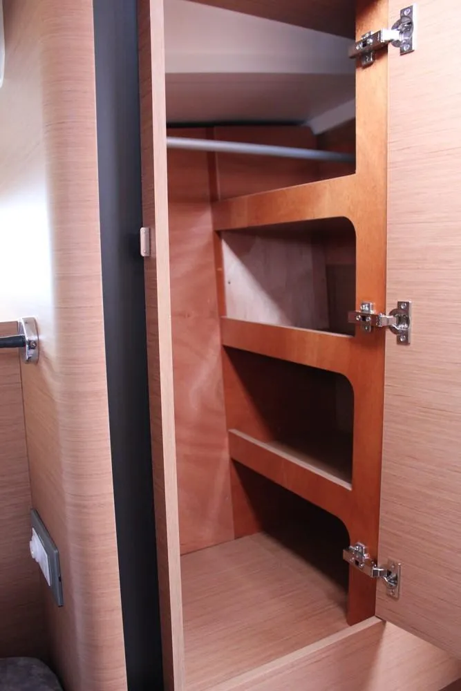 Slide: The Image of 2025 Jeanneau Sun Odyssey 440 interior wooden storage cabinet with shelves. - 32