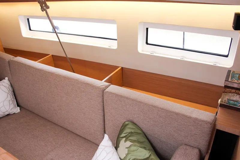 Slide: The Image of Interior of 2025 Jeanneau Sun Odyssey 440 yacht, featuring modern seating and windows. - 36