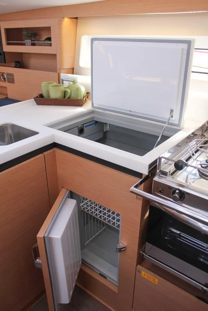 Slide: The Image of 2024 Jeanneau Sun Odyssey 490 yacht kitchen with modern appliances and storage. - 10