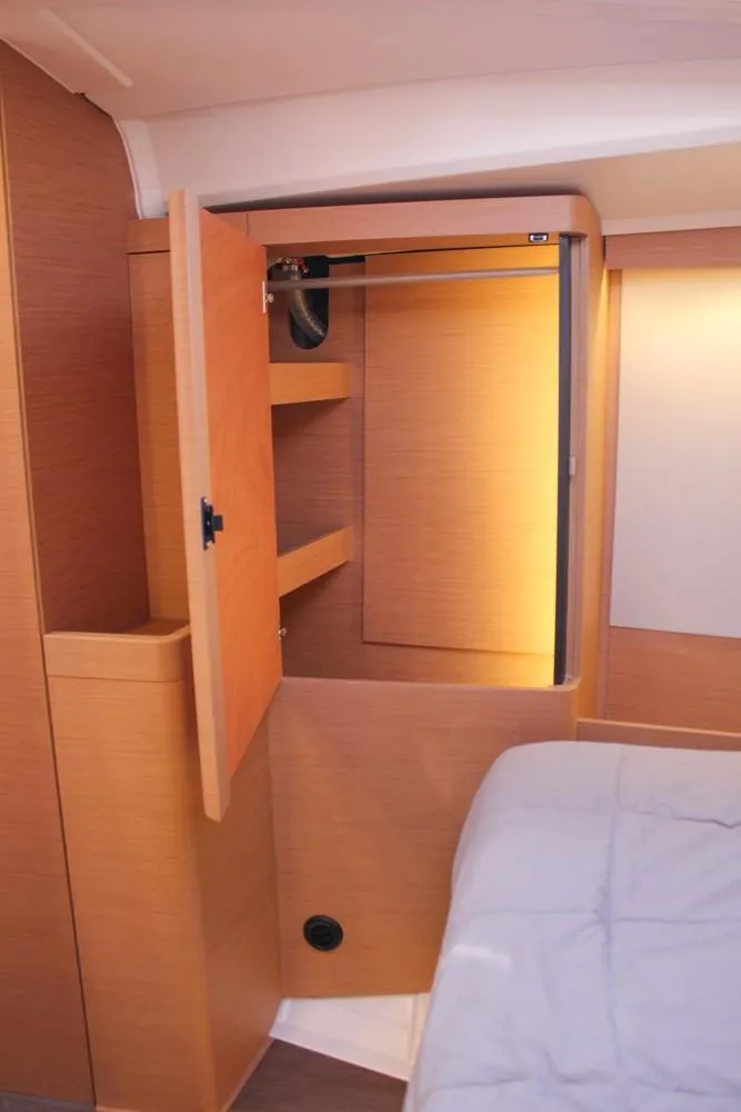 Slide: The Image of 2024 Jeanneau Sun Odyssey 490 cabin interior with open wooden closet. - 13