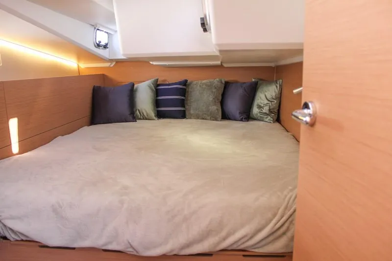 Slide: The Image of Cozy cabin interior of 2024 Jeanneau Sun Odyssey 490 yacht with plush bedding. - 16