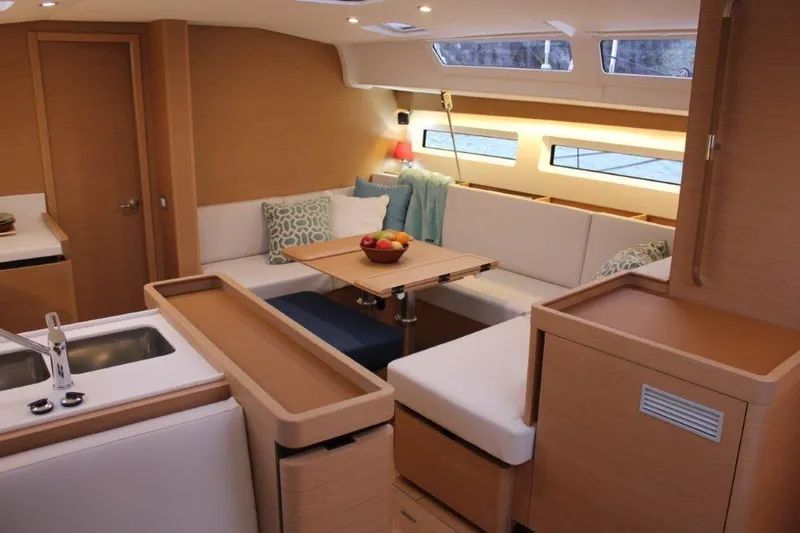 Slide: The Image of Luxurious interior of 2024 Jeanneau Sun Odyssey 490 yacht with modern seating and dining area. - 2