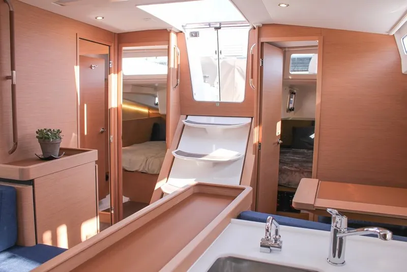 Slide: The Image of Interior of 2024 Jeanneau Sun Odyssey 490 sailboat, featuring modern wood finish and spacious layout. - 20