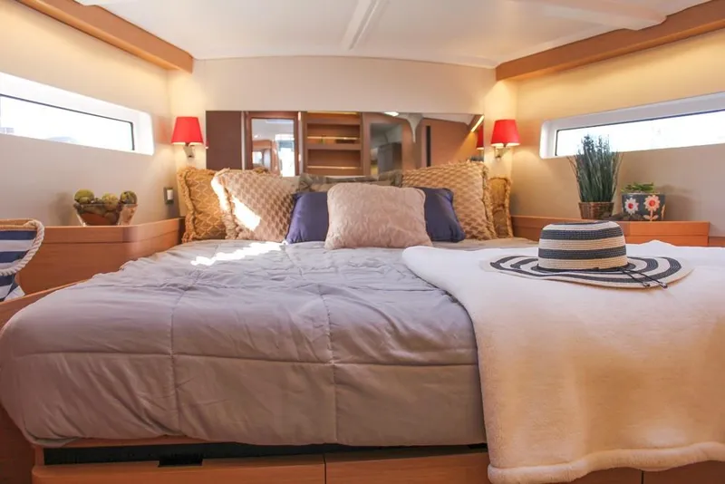 Slide: The Image of Luxurious cabin interior of 2024 Jeanneau Sun Odyssey 490 yacht, featuring cozy bedding and elegant decor. - 24