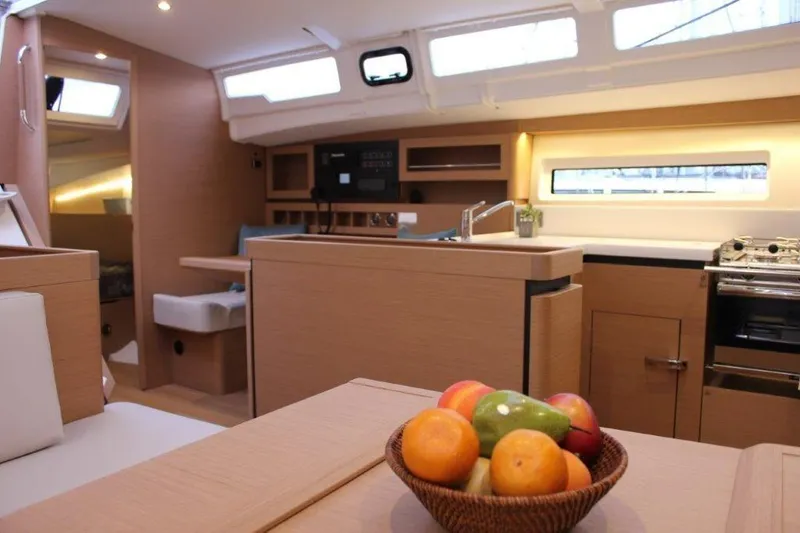 Slide: The Image of Modern interior of 2024 Jeanneau Sun Odyssey 490 yacht with fruit basket on table. - 29