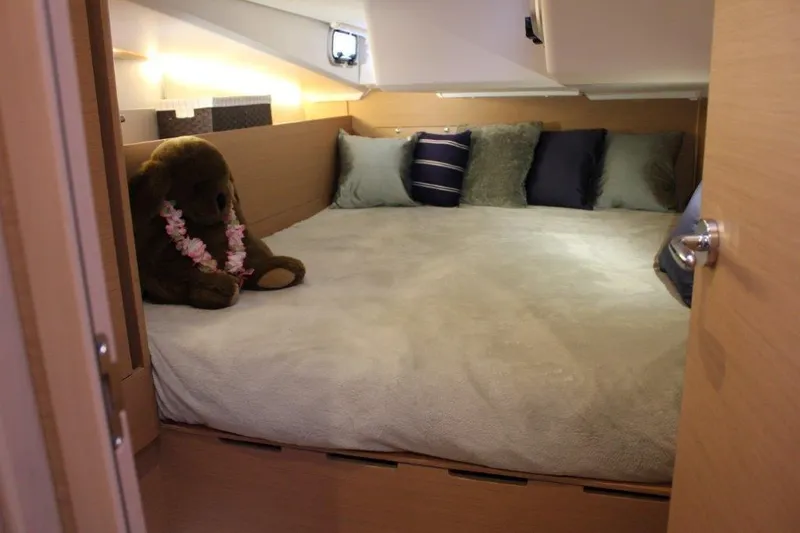 Slide: The Image of Cozy cabin interior of 2024 Jeanneau Sun Odyssey 490 with plush bedding and decorative pillows. - 31