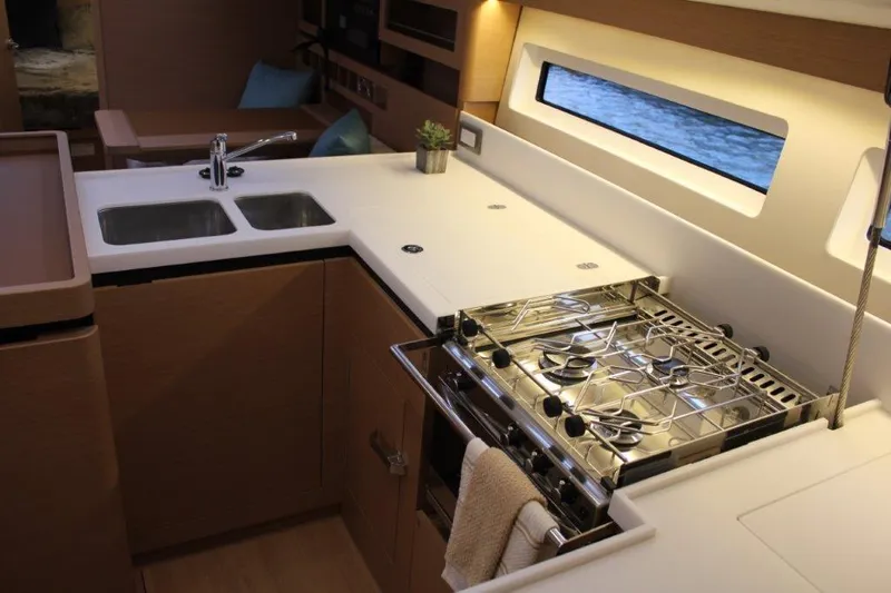 Slide: The Image of Modern kitchen in 2024 Jeanneau Sun Odyssey 490 yacht with stove and sink. - 36