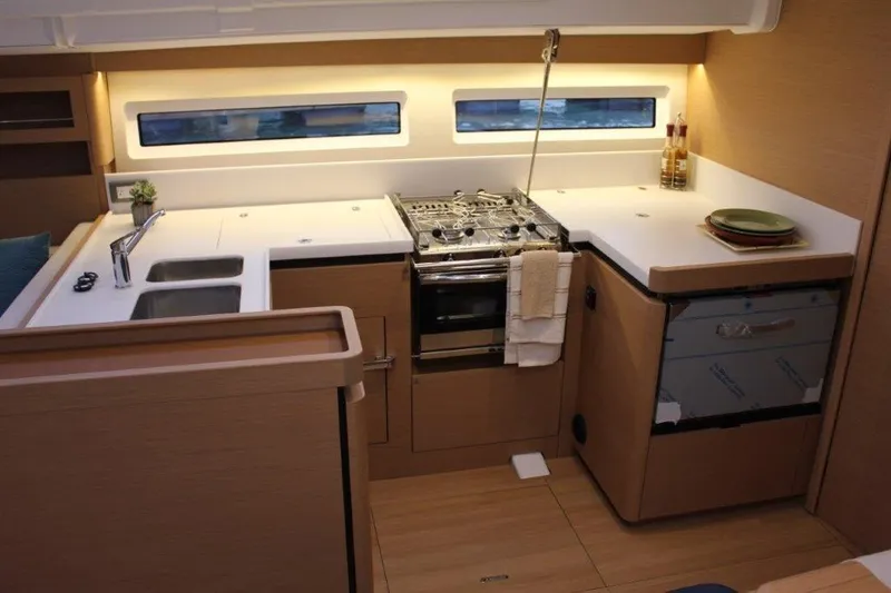 Slide: The Image of Modern kitchen in 2024 Jeanneau Sun Odyssey 490 yacht, featuring sleek countertops and appliances. - 39