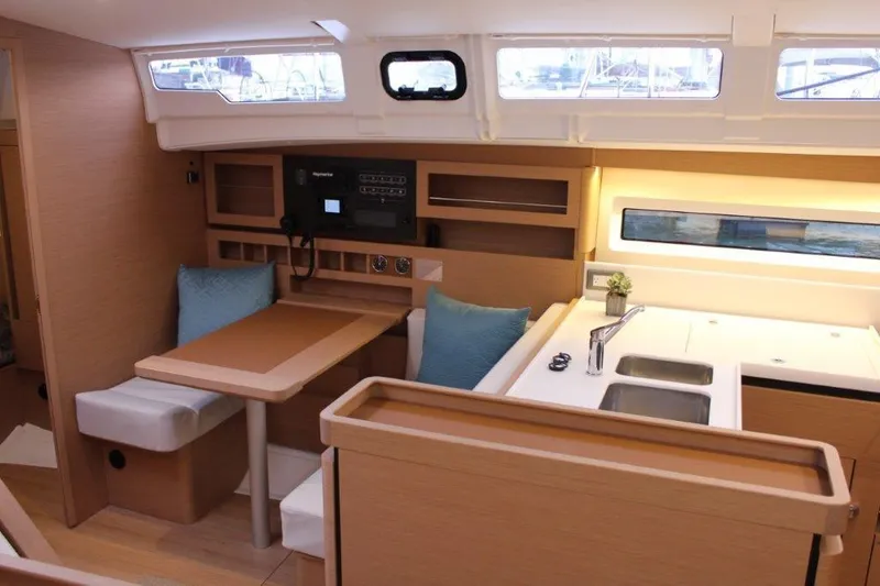 Slide: The Image of Interior of 2024 Jeanneau Sun Odyssey 490 yacht with modern kitchen and seating area. - 40